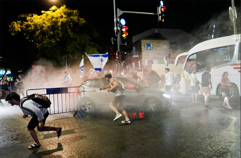 Η αστυνομία χρησιμοποίησε ένα κανόνι νερού στην Ιερουσαλήμ αργά την Κυριακή για να προσπαθήσει να διαλύσει τους αντικυβερνητικούς διαδηλωτές που έκλεισαν έναν κεντρικό δρόμο της πόλης.]